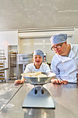 Students with Down Syndrome measuring dough in kitchen