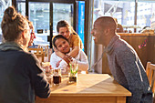 Affectionate women with Down Syndrome in cafe with friends