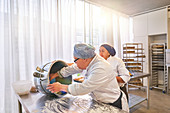 Chef and student with Down Syndrome baking in kitchen