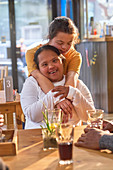 Portrait happy young women with Down Syndrome in cafe