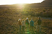Group watching elephants in sunny grassland South Africa