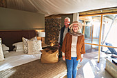 Senior couple arriving in safari lodge hotel room
