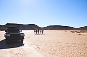 Group walking in sunny arid desert South Africa