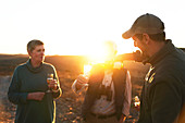 Safari tour guide pouring champagne for senior couple