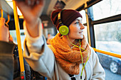 Woman listening to music with headphones on bus