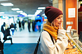 Woman ordering food at deli counter