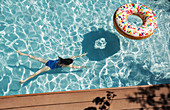 Girl swimming underwater in swimming pool