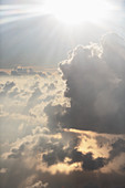 Aerial view sunbeams over ethereal, fluffy white clouds
