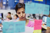Businesswoman planning, using adhesive notes in office