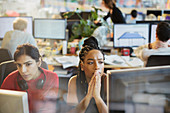 Serious businesswomen working at computers in office