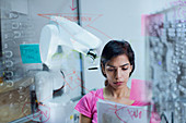 Female engineer programming robotic arm