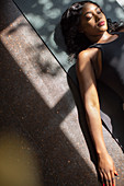 Serene woman laying on yoga mat