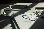 Retirement portfolio on desk with coffee and eyeglasses