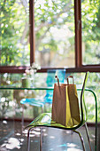 Brown shopping bag on dining chair
