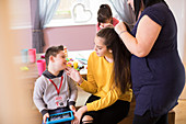 Family with Down Syndrome child bonding in dining room