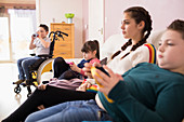 Siblings watching TV on sofa