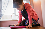 Curious girl using digital tablet