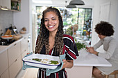 Portrait smiling woman cooking in kitchen