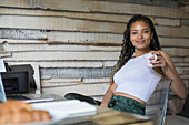 Portrait female entrepreneur working in home office