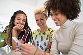 Women friends using smart phone