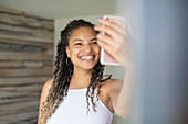 Woman taking selfie with camera phone