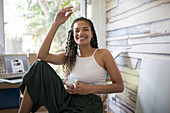 Portrait happy carefree woman in home office