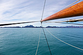 Wooden sailboat mast over blue Atlantic Ocean Greenland