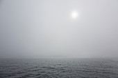 Thick grey fog over ethereal Atlantic Ocean