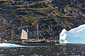 Ship and melting polar ice in Disko Bay Greenland