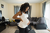 Beautiful pregnant woman holding stomach