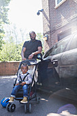 Portrait father and toddler son in stroller