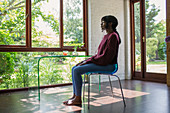 Serene woman meditating in tranquil home office