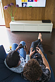Young couple playing video game in living room