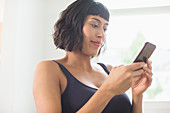 Woman in bra using smart phone