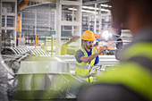 Male worker pointing, working in steel factory