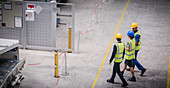 Workers walking and talking in factory