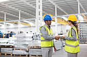 Supervisors handshaking in warehouse