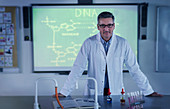 Male science teacher teaching DNA lessonin classroom