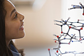 Curious girl student examining molecular structure