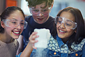 Students watching chemical reaction in classroom