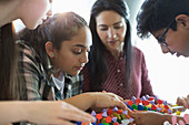 Curious students examining DNA model in classroom