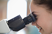 Girl student using microscope