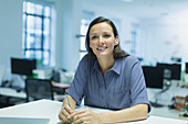 Portrait smiling, confident businesswoman in office