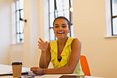 Smiling, confident businesswoman talking in meeting