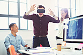 Computer programmers testing virtual reality simulator