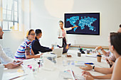Female designer at television screen leading meeting