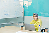 Businesswoman working at laptop in office