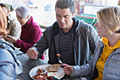 Couple sharing breakfast at restaurant outdoor patio