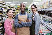 Portrait confident, smiling grocers working in supermarket