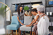 Women shopping for dining chairs in home decor shop